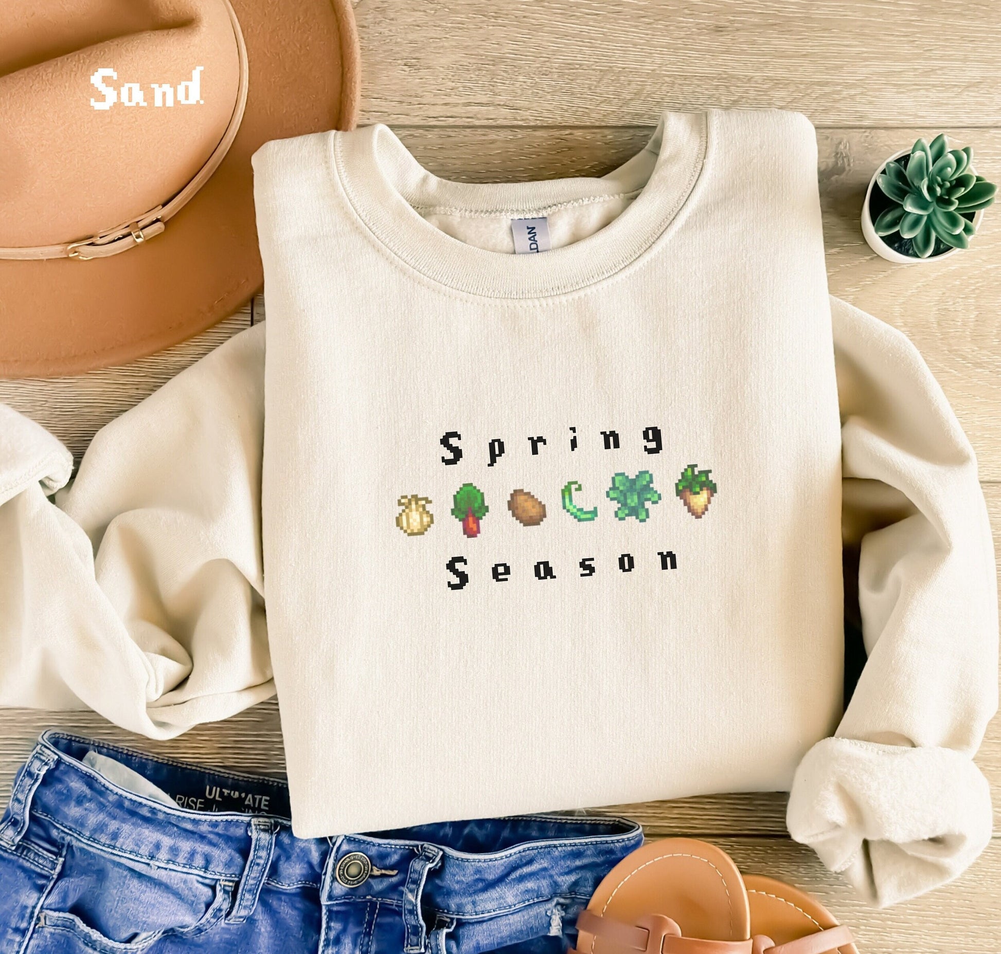 Spring Season Sweatshirt featuring the crops from stardew valley, garlic, rhubarb, potato, green bean, kale, and parsnip. various colors are available.