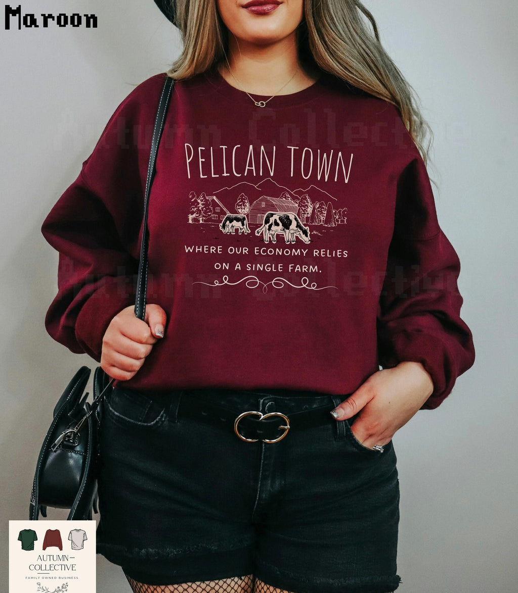 Pelican Town Sweatshirt - Where our economy relies on a single farm.