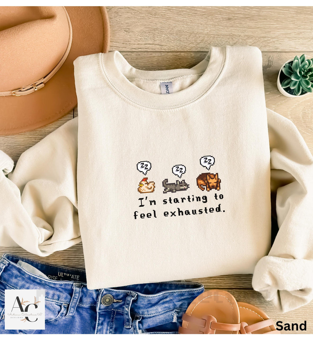 I&#39;m Starting To Feel Exhausted sleepy chicken, sleepy cat, and sleepy dog stardew valley sweatshirt in color Sand.